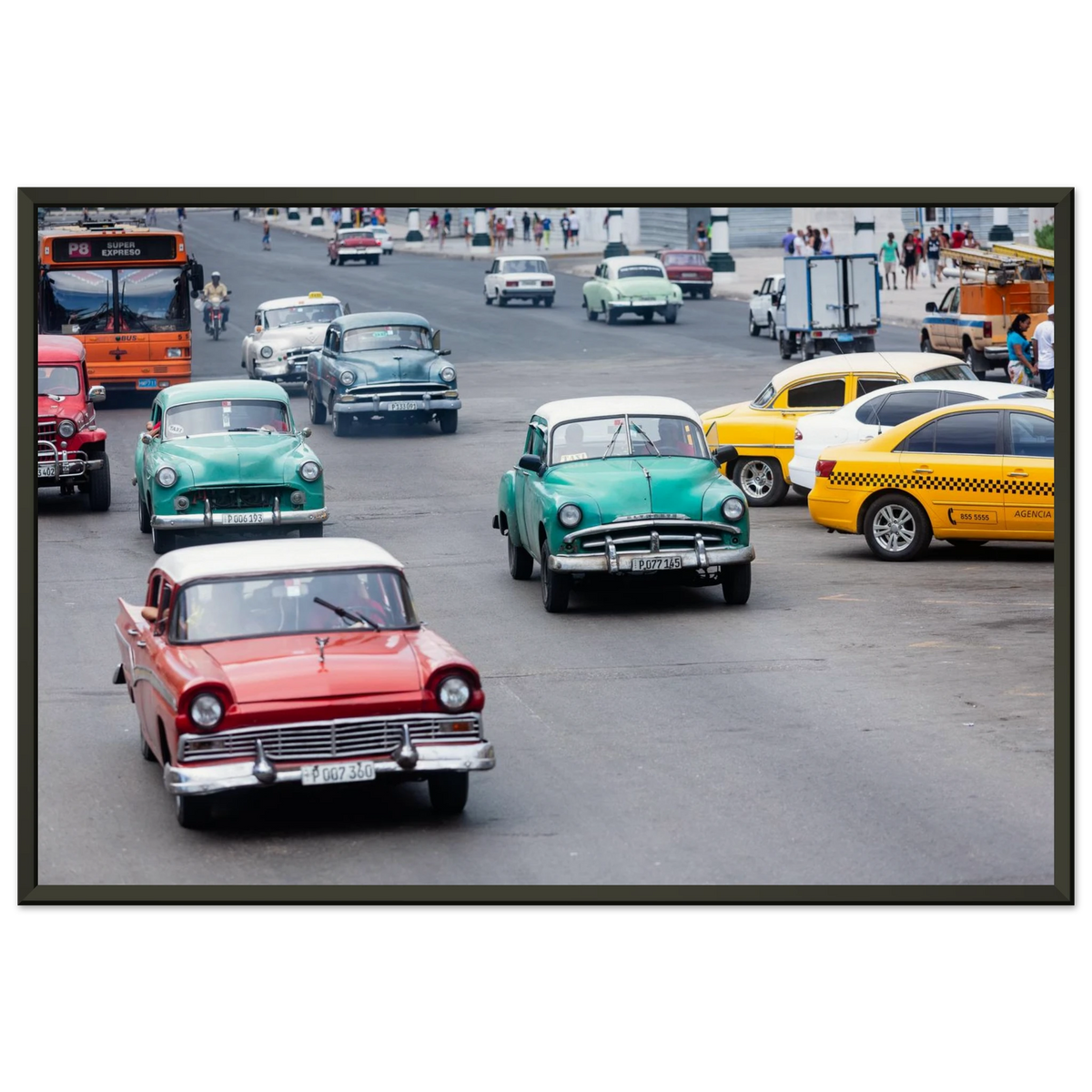 Classic vintage colorful cars driving down a bustling avenue in Havana, Cuba - Fine art street photography print by Paulo Côrte-Real