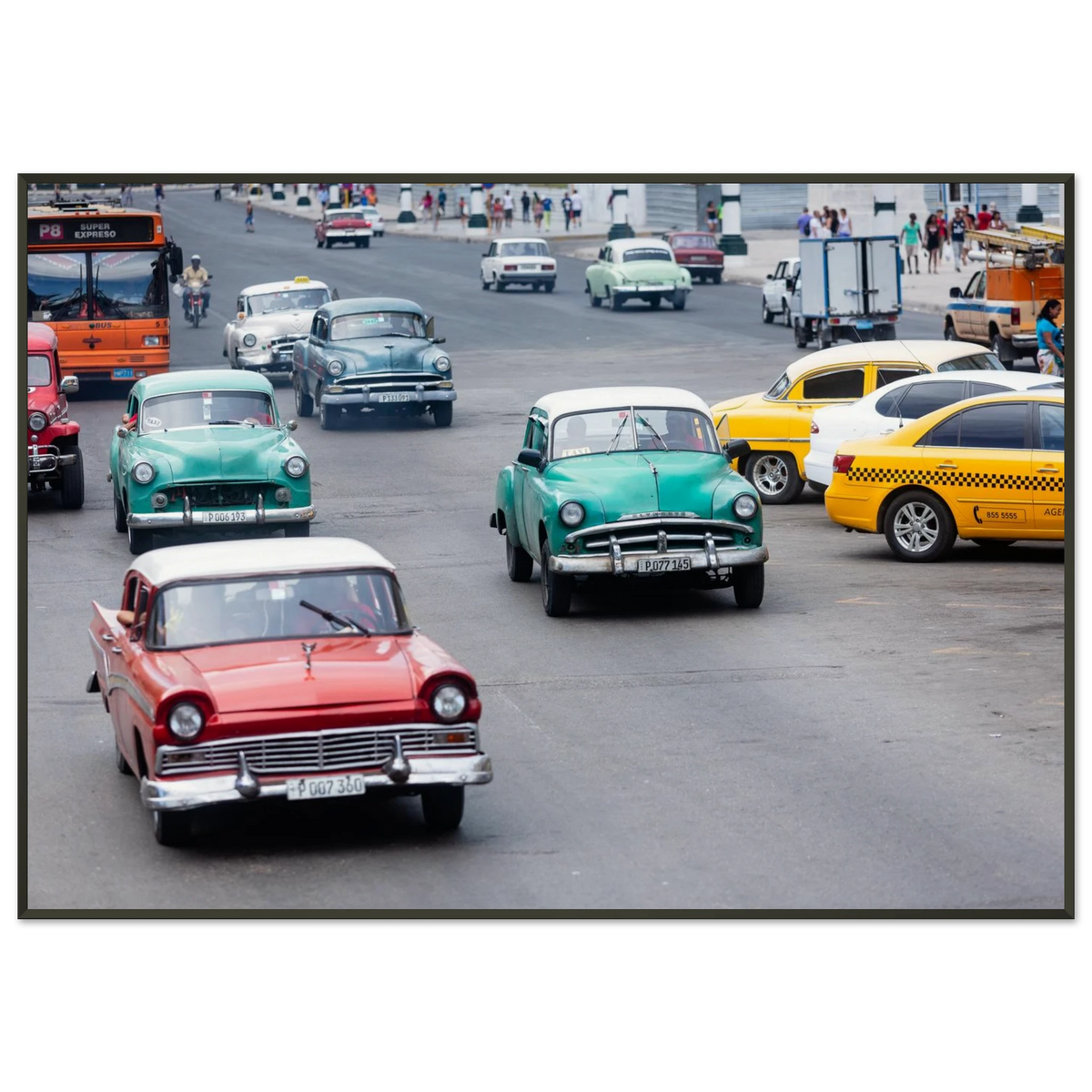 Classic vintage colorful cars driving down a bustling avenue in Havana, Cuba - Fine art street photography print by Paulo Côrte-Real