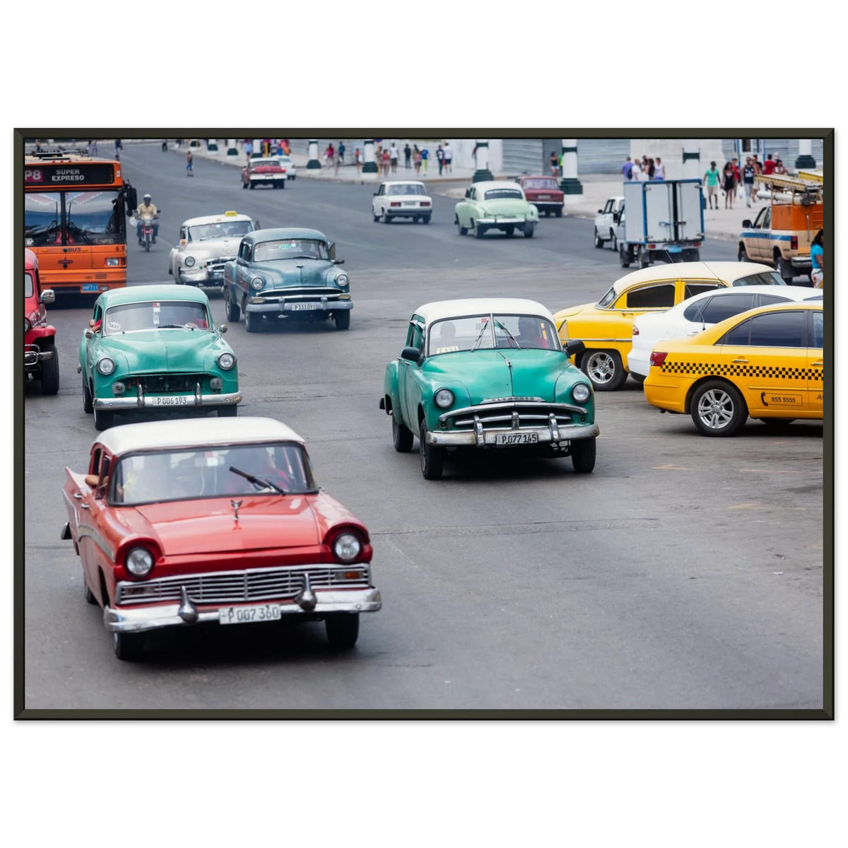 Classic vintage colorful cars driving down a bustling avenue in Havana, Cuba - Fine art street photography print by Paulo Côrte-Real